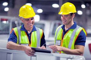Two colleagues, with cheerful facial expressions, engaged in a task.